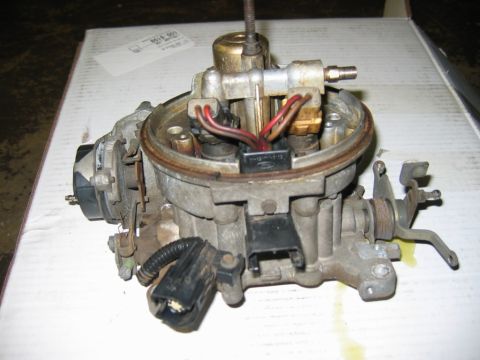 1985 Ford Crown Victoria LTD - Close-up of a Ford carburetor, likely a replacement part, on a white surface.