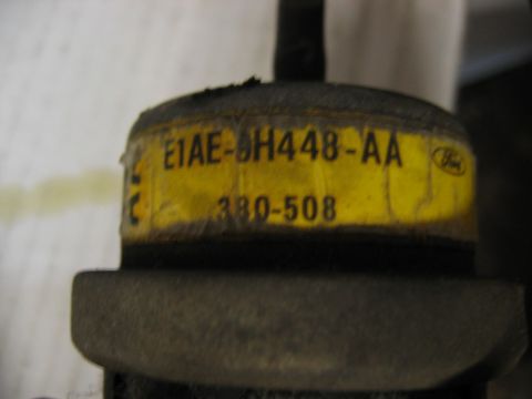 1985 Ford Crown Victoria LTD - Close-up of a part with a yellow label displaying part numbers E1AE-0H448-AA and 380-508.