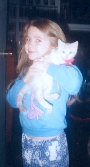 1991 Ford Bronco - Girl holding a kitten. The photo has a watermark for SUPERMOTORS.