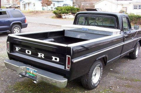 1968 Ford F-100 - This black Ford pickup truck has a diamond plate toolbox in its bed and a license plate reading 554 ALL.