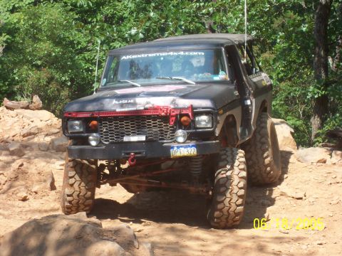 1978 Ford Bronco - Modified 1978 Ford Bronco tackling rough terrain on an off-road trail.