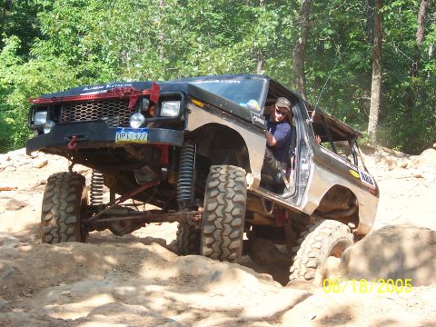 1978 Ford Bronco - This heavily modified Ford Bronco navigates a challenging off-road course with large tires and lifted suspension.