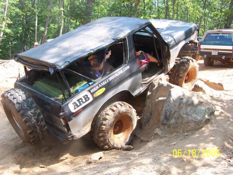 1978 Ford Bronco - This vehicle is shown off-roading over rocks with a second vehicle visible in the background.