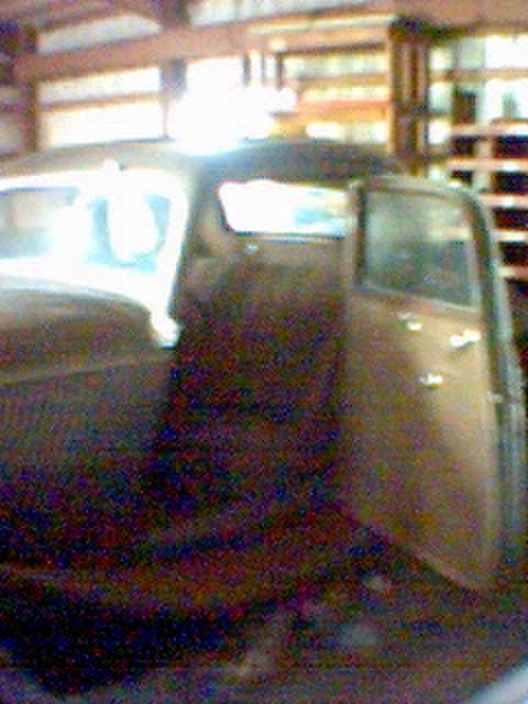 1994 Ford Bronco - The interior of an old car is visible, with the passenger door ajar.