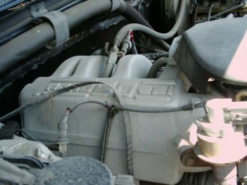 1994 Ford Bronco - This is a close-up view of an engine's intake manifold and associated components.