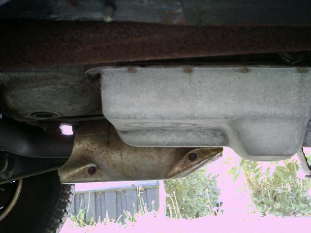 Underside view of transmission pan and exhaust pipe