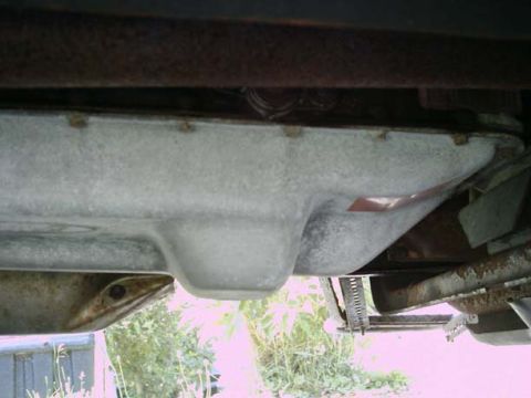 1994 Ford Bronco - Underside view of a transmission pan, showing its shape and mounting bolts.