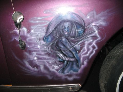 1986 Ford Bronco - Airbrushed artwork covers the side of a purple vehicle, depicting a mystical woman surrounded by lightning and stars.