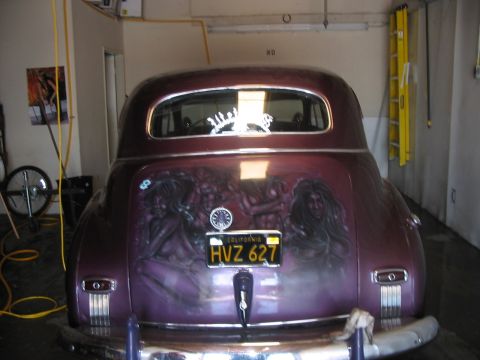 1986 Ford Bronco - Rear view of a customized vintage car a mural and California license plate HVZ 627.