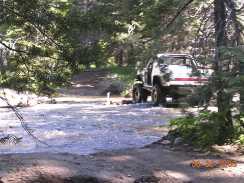 1994 Ford Bronco - Modified 1994 Ford Bronco navigates a stream during an off-road excursion.