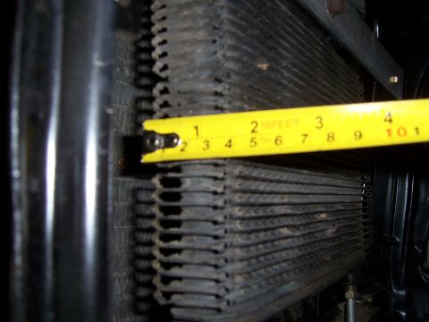 1983 Ford Bronco - Measuring radiator fins with a yellow tape measure.