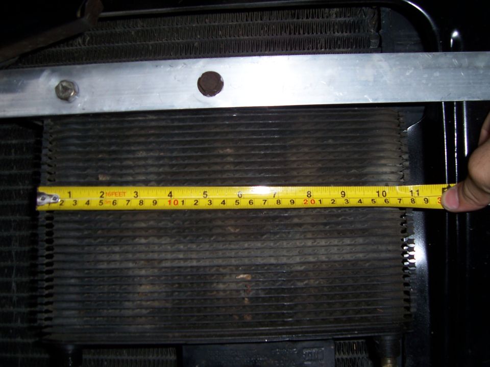 Radiator with a yellow measuring tape across it, showing approximately 11 inches