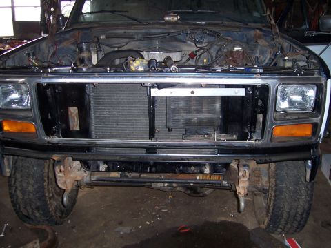 1983 Ford Bronco - Truck front end with hood up, revealing the engine bay and radiator. Appears to be an early 1980s model.