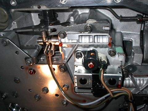 1985 Mercury Grand Marquis - Internal view of an automatic transmission valve body, showing solenoids and linkages.