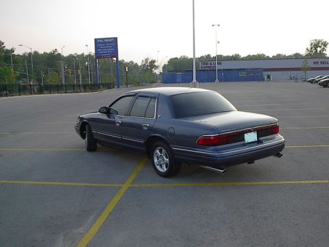 1985 Mercury Grand Marquis - This dark blue 1996 Mercury Grand Marquis is seen from the rear in a parking lot with a Walmart sign in the background.