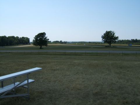 1998 Ford Taurus - A wide view of an outdoor venue with bleachers in the foreground and a road in the distance.