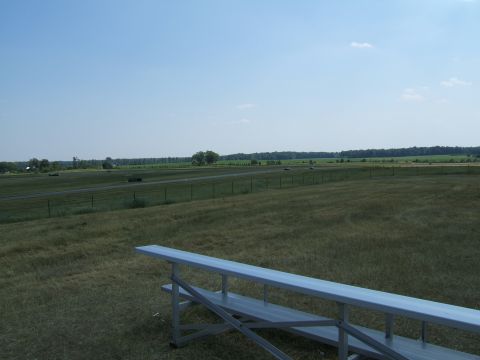 1998 Ford Taurus - A wide view of a rural landscape bleachers in the foreground and a distant road.