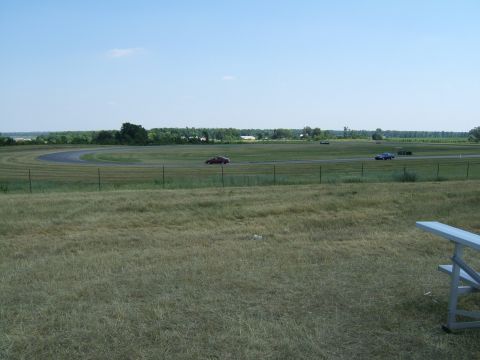 1998 Ford Taurus - Cars on a race track during a sunny day.
