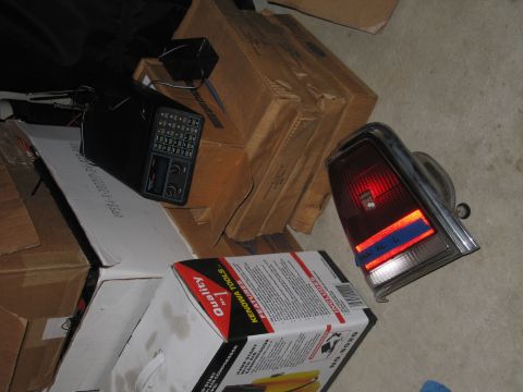 1991 Ford LTD Crown Victoria - A car tail light assembly is shown next to several cardboard boxes.