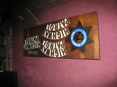1991 Ford LTD Crown Victoria - A wooden plaque displays a California Highway Patrol star badge and several "HIGHWAY PATROL" letterings.