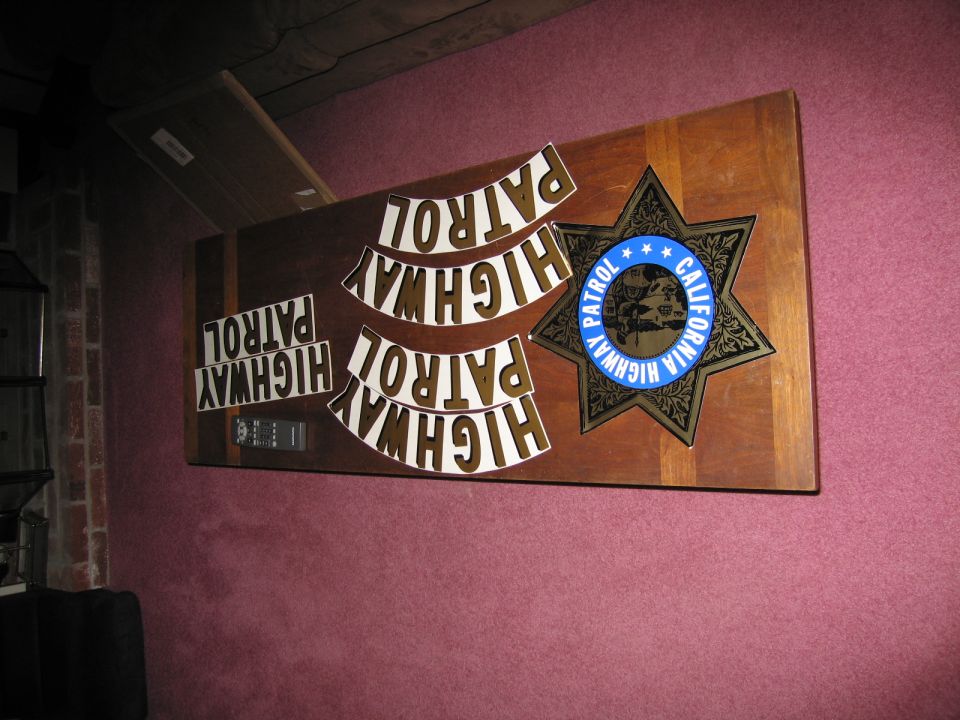 Wooden plaque with California Highway Patrol star badge and multiple "HIGHWAY PATROL" letterings