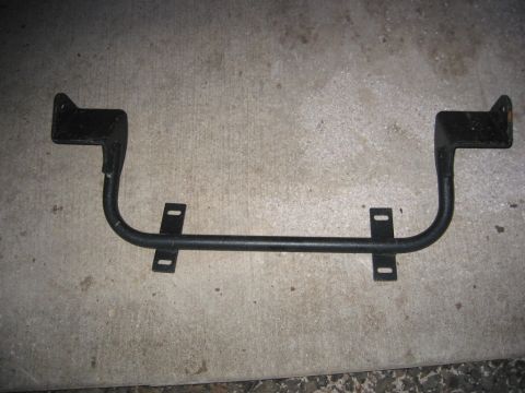 1991 Ford Explorer - This is a metal bracket, likely a vehicle part, shown against a concrete surface.