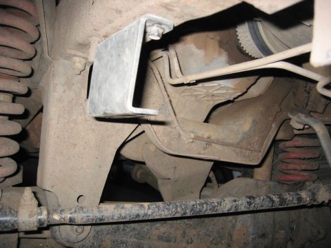 1991 Ford Explorer - Close-up view of a vehicle's undercarriage, revealing suspension parts and frame structure.