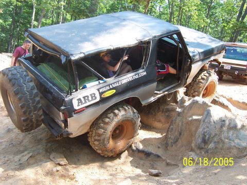 1978 Ford Bronco - This modified 1978 Ford Bronco tackles a rocky trail with its top off and oversized tires.