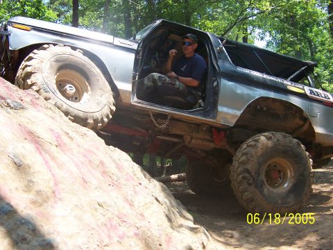 1978 Ford Bronco - A modified Bronco navigates a steep, rocky incline on an off-road trail.