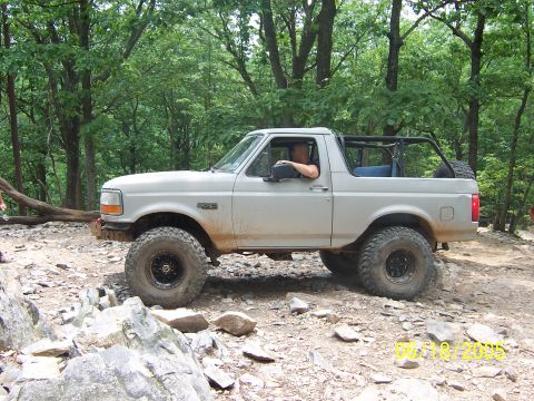 1978 Ford Bronco - This Ford Bronco is navigating a challenging off-road course with large rocks and steep inclines.