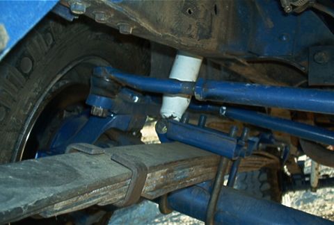 1986 Ford Bronco - Undercarriage view of a vehicle's suspension system, showing various mechanical components.
