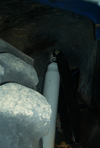 1986 Ford Bronco - Close-up view of suspension components, including a shock absorber.