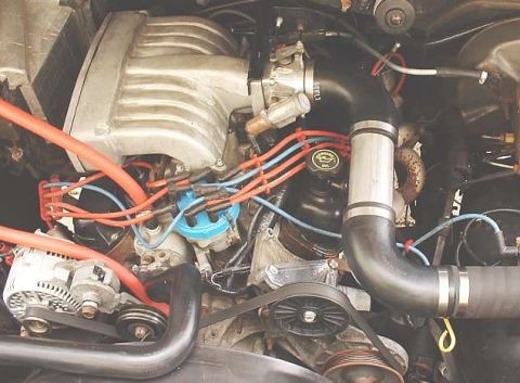 1986 Ford Bronco - Close-up view of a vehicle's engine bay, showing various components and wiring.