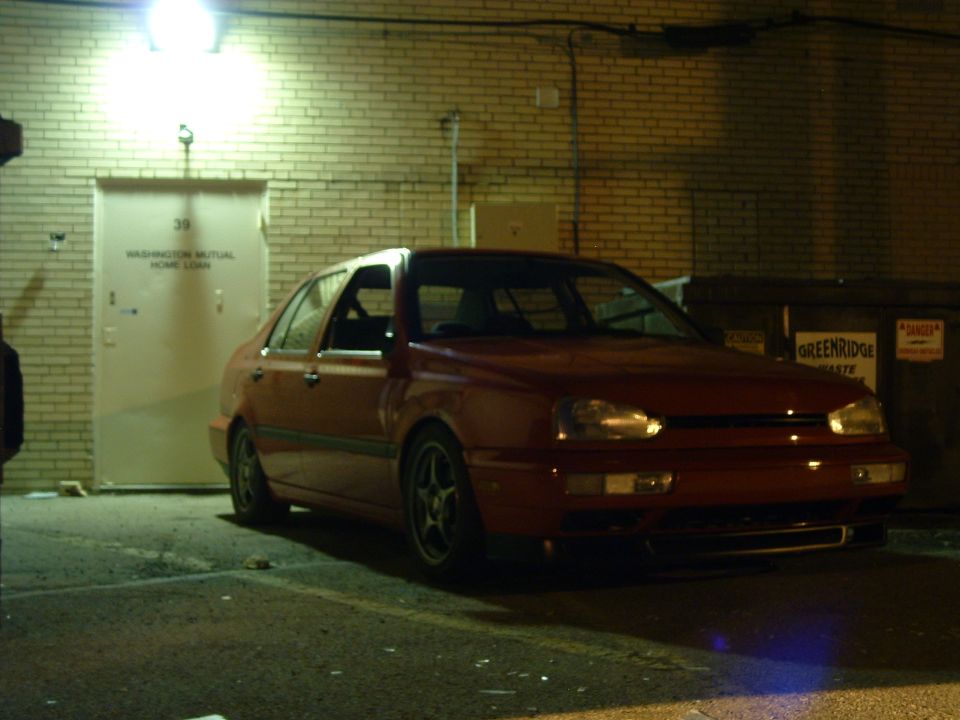 red sedan parked in front of a brick building with a door labeled 39 Washington Mutual Home Loan
