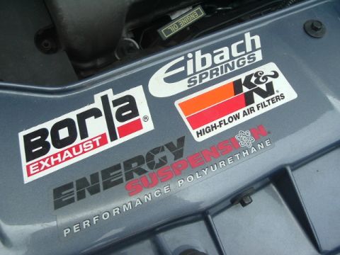 1993 Ford Taurus - Performance stickers adorn the engine bay of a vehicle, including Borla, Eibach, K&N, and Energy Suspension brands.