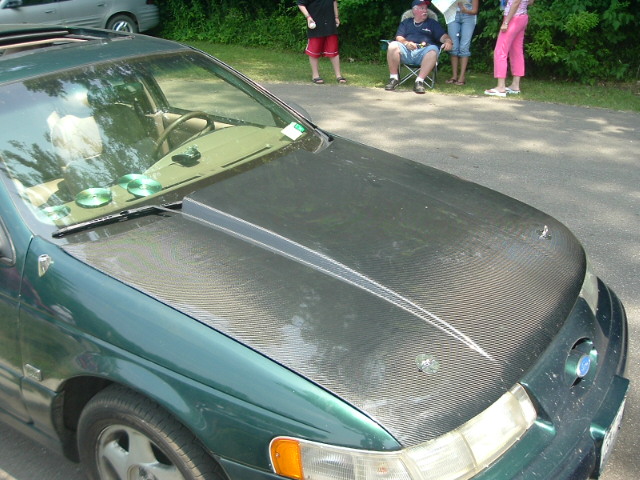 Green 1993 Ford Taurus with carbon fiber hood and scoop