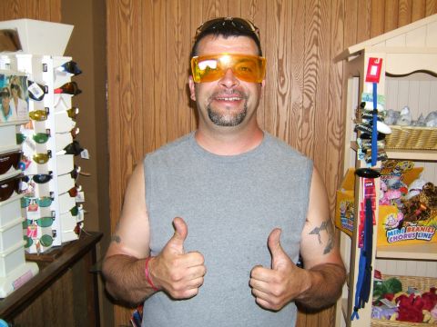 1998 Ford Taurus - A man poses for a photo while wearing oversized orange sunglasses and giving a thumbs-up gesture.