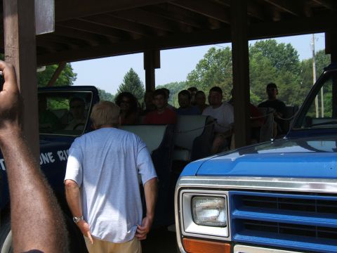 1998 Ford Taurus - A group enjoys a covered wagon ride, with a blue truck visible nearby.