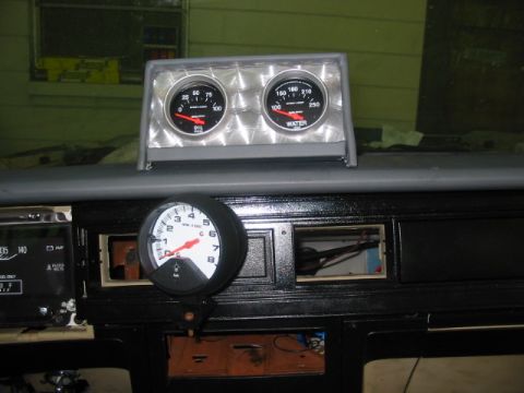 1985 Ford LTD Crown Victoria - Aftermarket gauges are installed on the dashboard of a vehicle.