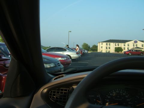 1998 Ford Taurus - A view from inside a car shows a parking lot filled with vehicles under a clear sky.