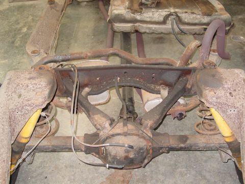 1967 Pontiac GTO - Underside view of a vehicle's rear axle and suspension system, showing rusted components.