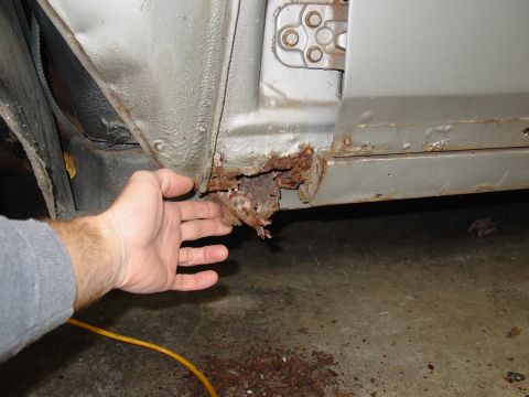1967 Pontiac GTO - Severe rust damage is visible on the lower door sill of a silver vehicle.