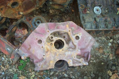 1994 Ford F-150 - Several heavily rusted engine blocks and parts are piled up outdoors on the ground.