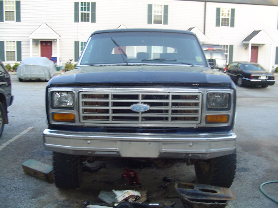 Dark blue Ford Bronco front view with chrome grille and rectangular headlights