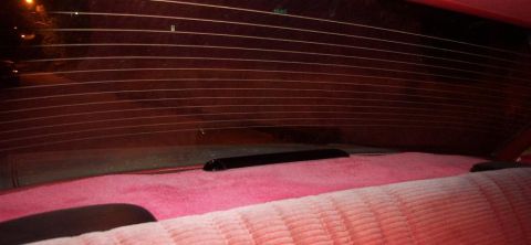1985 Ford Crown Victoria LTD - Interior view of the rear seat and window of a 1985 Ford Crown Victoria LTD.