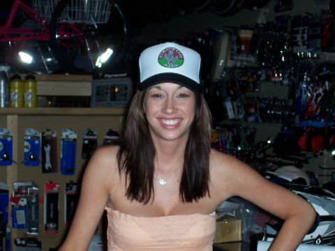 1994 Ford Bronco - Woman in a store, possibly a bicycle shop, with merchandise on shelves behind her.