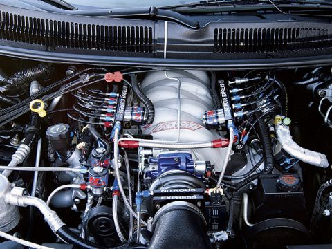 2000 Ford Crown Victoria - Close-up view of a modified engine bay a Nitrous Express system and custom fuel lines.