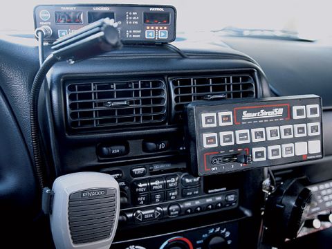 2000 Ford Crown Victoria - Interior view of a police vehicle's dashboard, showing various communication and control equipment.