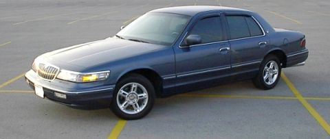 1985 Mercury Grand Marquis - This blue sedan appears to be a later model Mercury Grand Marquis, not a 1985 model as suggested by the registry.
