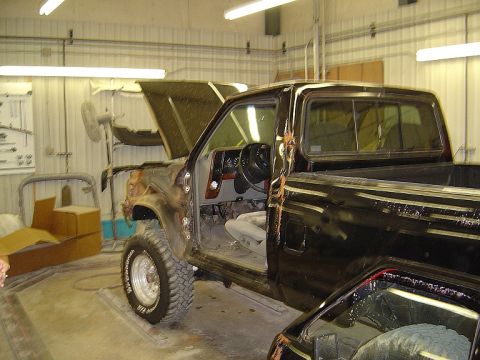 1989 Ford Ranger - This 1989 Ford Ranger is in a repair shop with its hood and driver's door open, showing its interior and engine bay.
